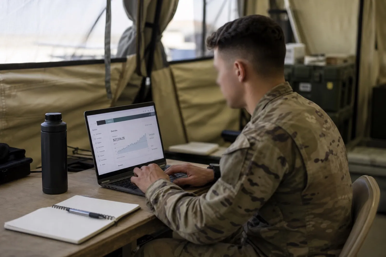 Deployed service member using a laptop to manage a Thrift Savings Plan account