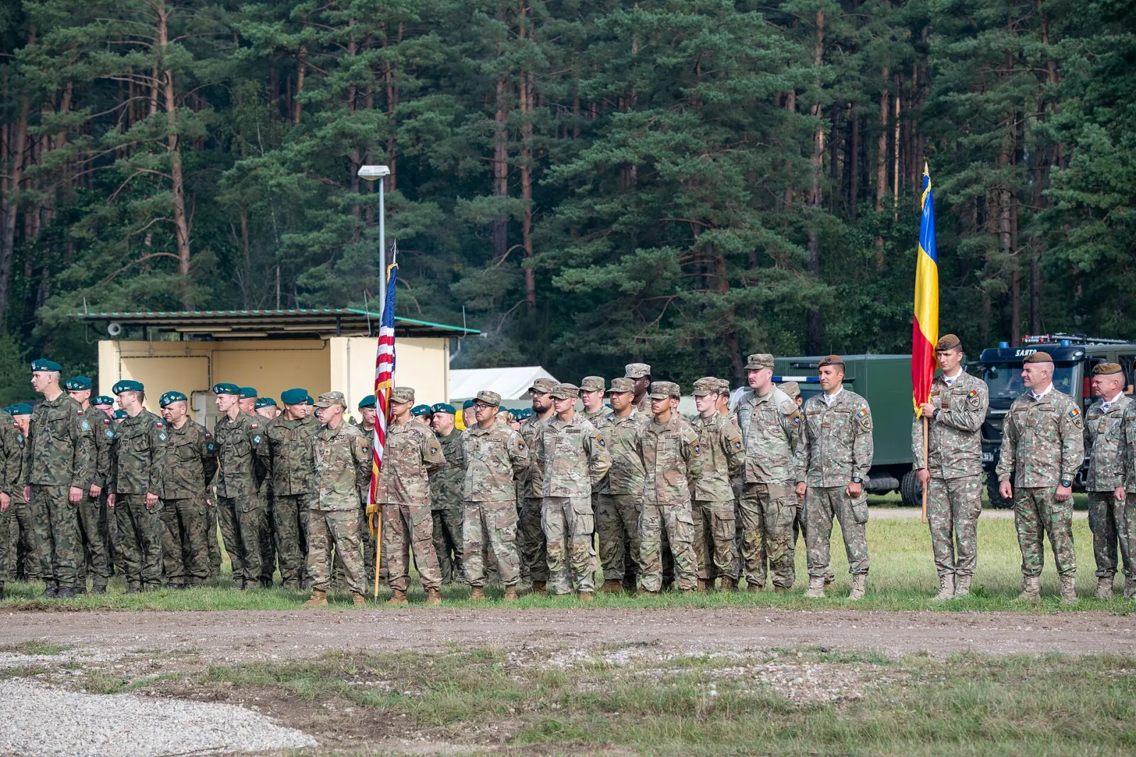 Service members in formation reviewing pay statements as the 2026 military pay raise takes effect