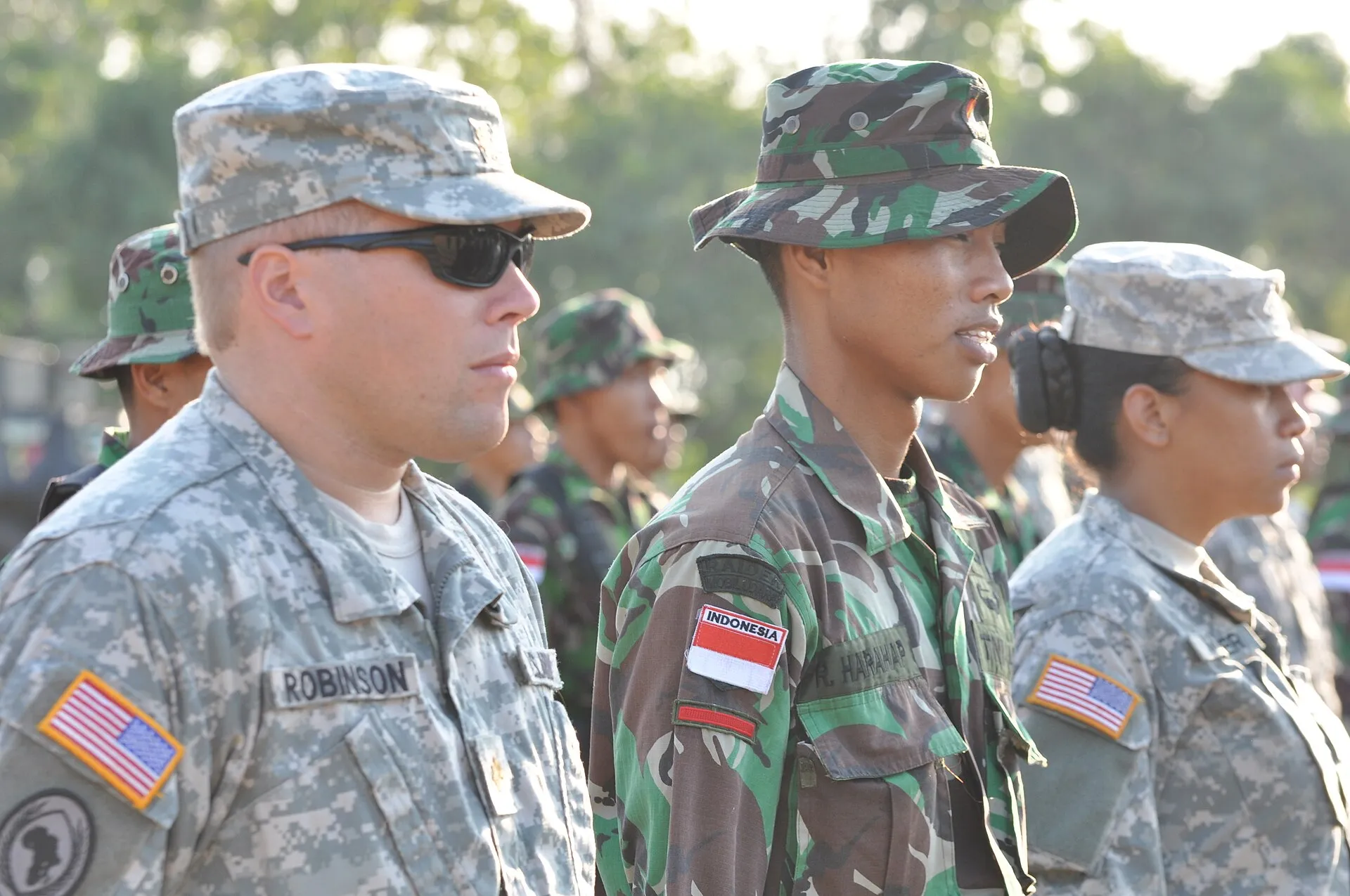 National Guard soldiers standing in formation during a ceremony with the American flag